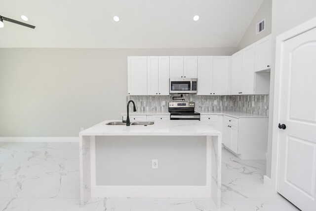 kitchen featuring sink, light stone countertops, white cabinets, and appliances with stainless steel finishes