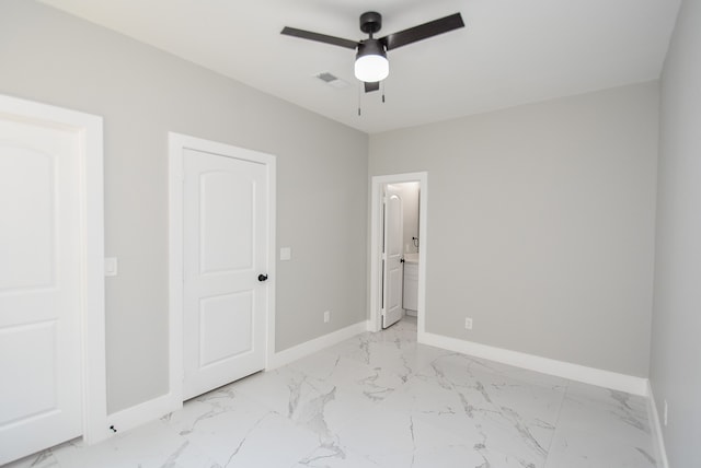 unfurnished bedroom with ceiling fan and ensuite bath