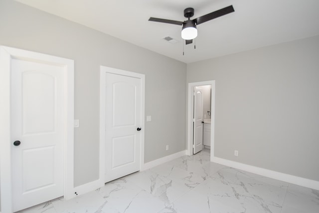 unfurnished bedroom with ceiling fan and connected bathroom