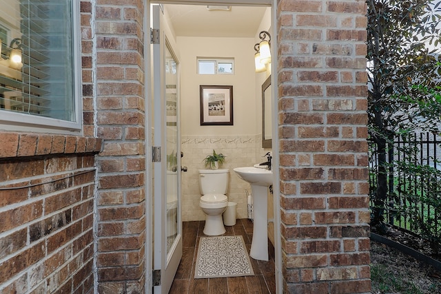 bathroom with wood-type flooring and toilet