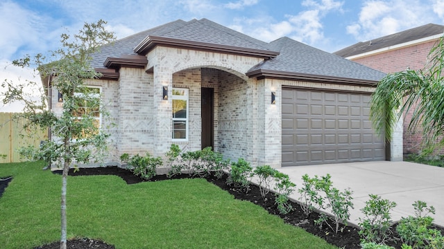 view of front of property with a front lawn and a garage