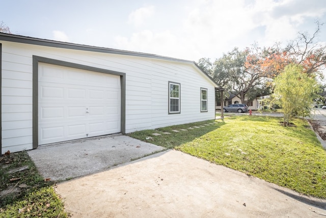 garage with a yard and wooden walls