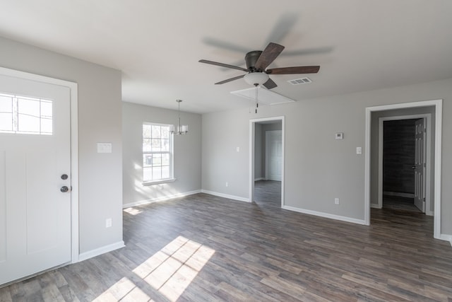 foyer entrance with ceiling fan with notable chandelier and dark hardwood / wood-style floors