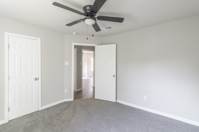 unfurnished bedroom with ceiling fan and carpet floors