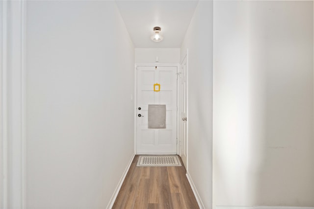 corridor with hardwood / wood-style floors