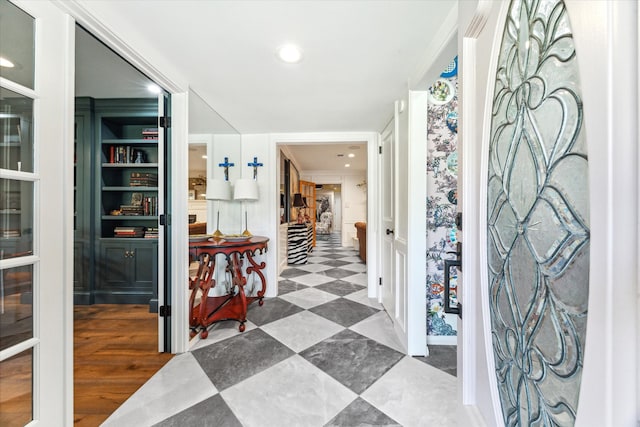 foyer featuring crown molding and hardwood / wood-style floors