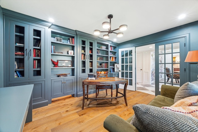 office area featuring french doors, light hardwood / wood-style floors, and a chandelier