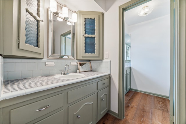 bathroom with wood-type flooring, backsplash, and vanity