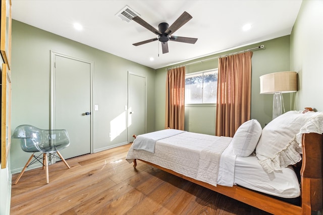 bedroom with light hardwood / wood-style flooring and ceiling fan