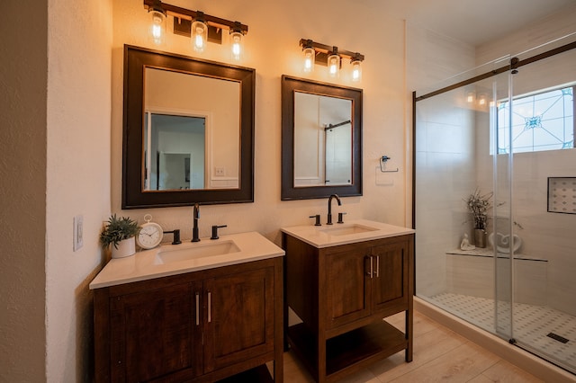 bathroom with vanity and a shower with door