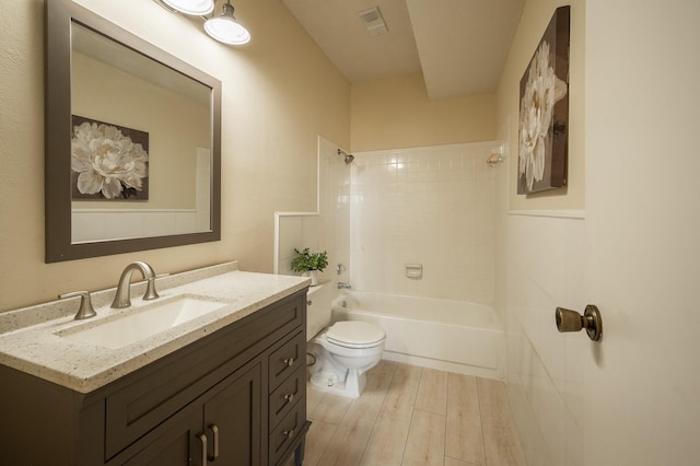 full bathroom featuring vanity, toilet, wood-type flooring, and tiled shower / bath