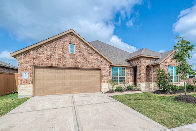 view of front of house with a garage and a front lawn