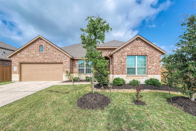 view of front of home featuring a front yard and a garage