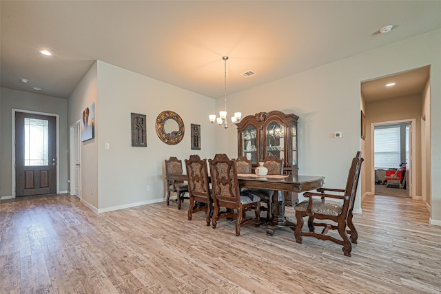 dining room with a chandelier and light wood-type flooring