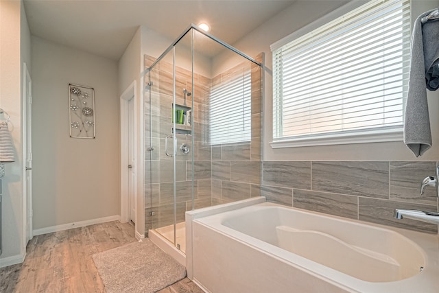 bathroom featuring hardwood / wood-style floors and independent shower and bath