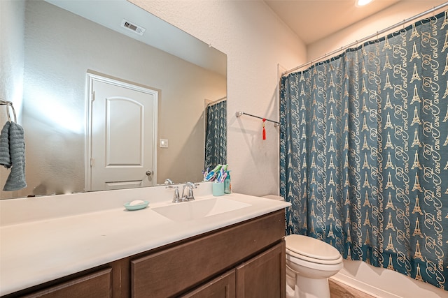 full bathroom featuring shower / bath combo with shower curtain, vanity, and toilet