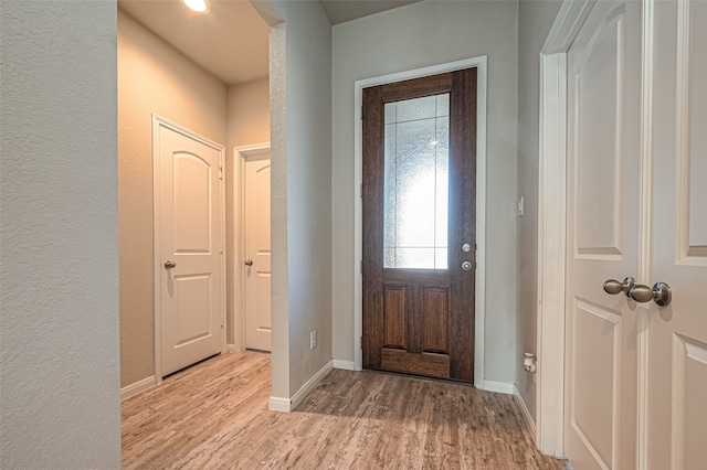 foyer entrance with light hardwood / wood-style floors