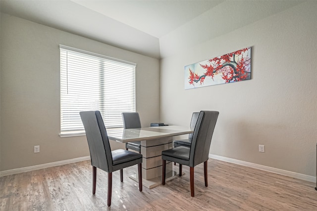 dining room with light wood-type flooring and plenty of natural light