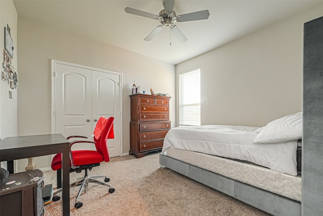 carpeted bedroom featuring a closet and ceiling fan