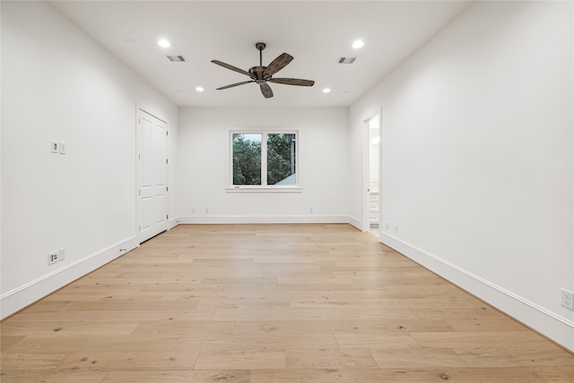 empty room with ceiling fan and light wood-type flooring