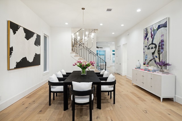 dining room with a chandelier and light hardwood / wood-style flooring