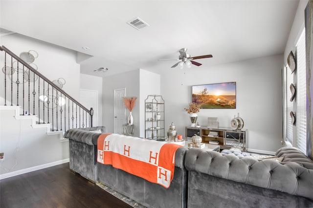 living room featuring ceiling fan and dark hardwood / wood-style flooring