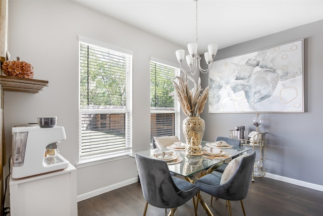 dining room featuring dark wood-type flooring and an inviting chandelier