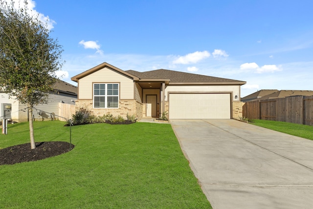 view of front of property featuring a garage and a front lawn