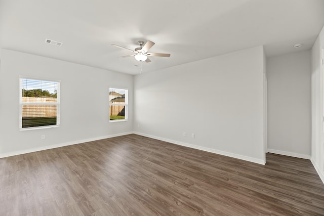 unfurnished room featuring ceiling fan and dark hardwood / wood-style flooring