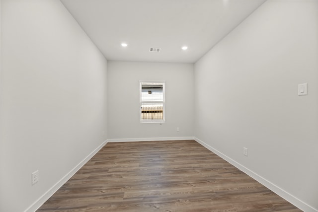 spare room featuring dark wood-type flooring