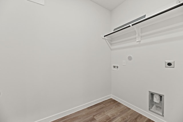 washroom featuring hardwood / wood-style floors, electric dryer hookup, hookup for a gas dryer, and hookup for a washing machine