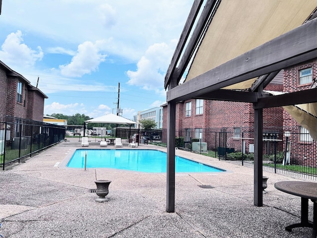 community pool featuring fence and a patio