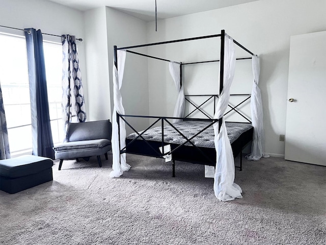 carpeted bedroom featuring baseboards