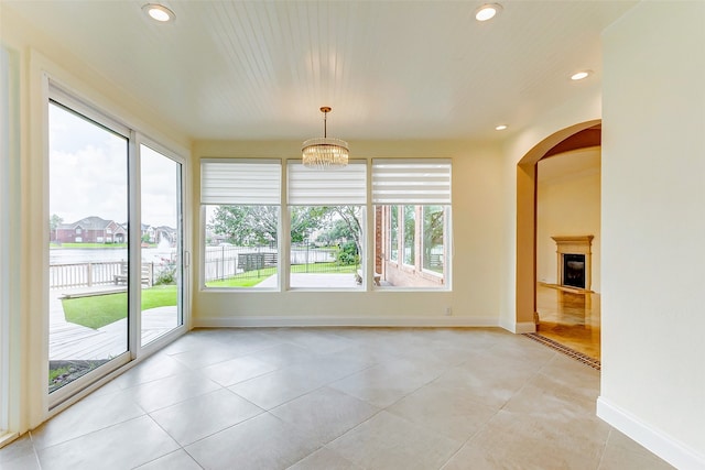 interior space featuring an inviting chandelier and light tile patterned floors