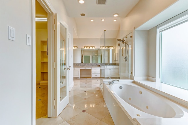 bathroom featuring tile patterned floors, plenty of natural light, vanity, and independent shower and bath