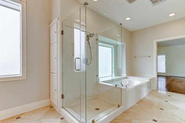 bathroom featuring tile patterned flooring and plus walk in shower