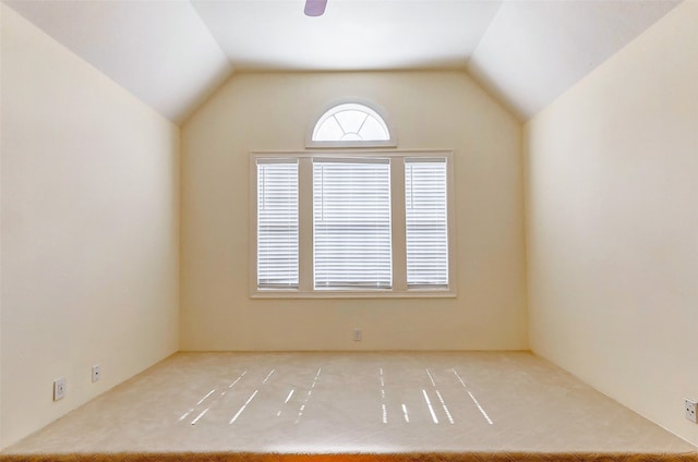 empty room featuring vaulted ceiling