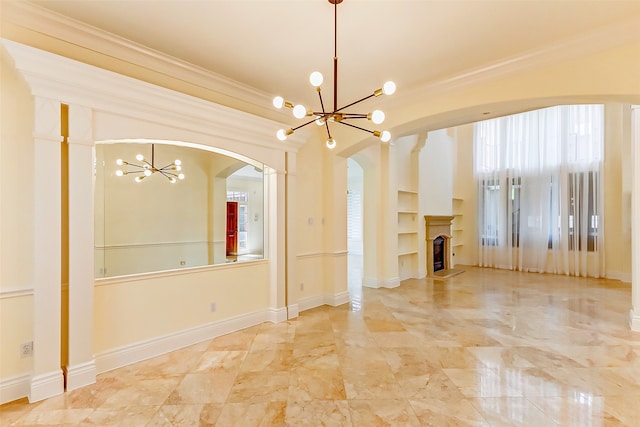 unfurnished living room with built in features, ornamental molding, and a notable chandelier