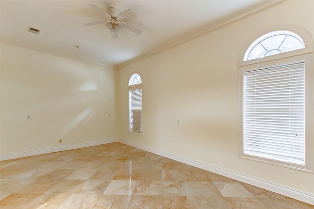 empty room with ornamental molding and ceiling fan