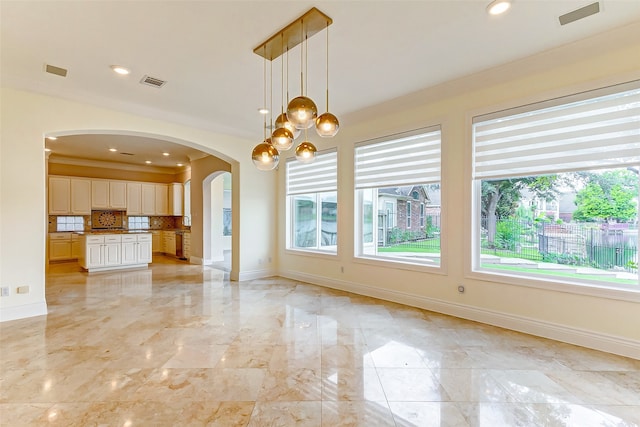 interior space featuring ornamental molding and an inviting chandelier