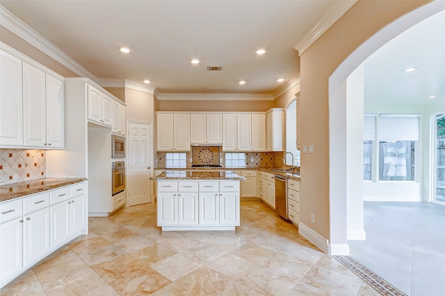 kitchen featuring appliances with stainless steel finishes, backsplash, and stone countertops