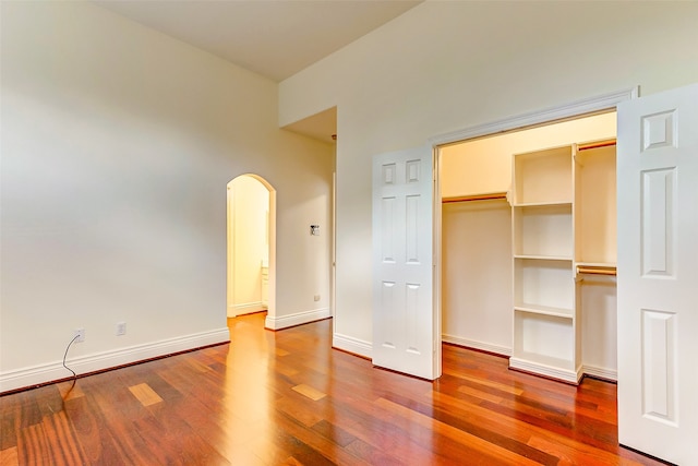 unfurnished bedroom with a closet and wood-type flooring