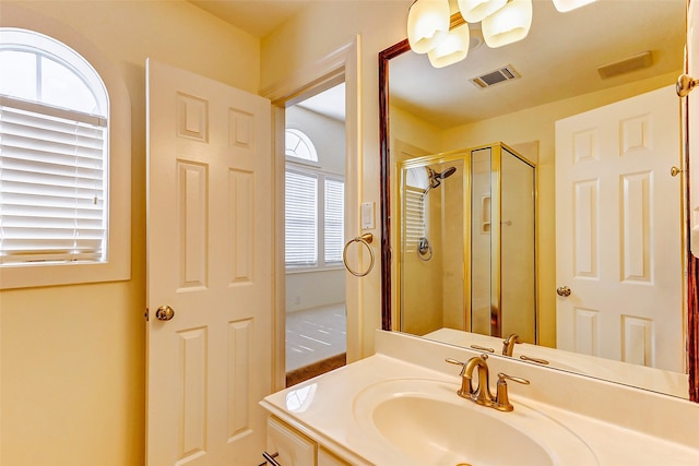 bathroom with vanity and a shower with shower door