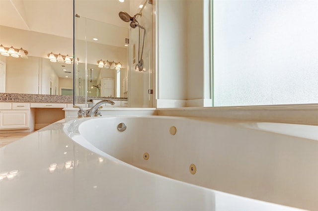 bathroom featuring vanity and plus walk in shower