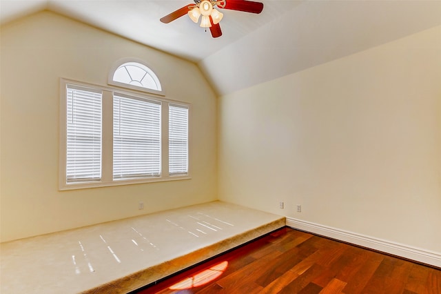 unfurnished room with lofted ceiling and hardwood / wood-style floors