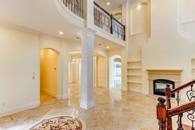 interior space with built in shelves and an inviting chandelier