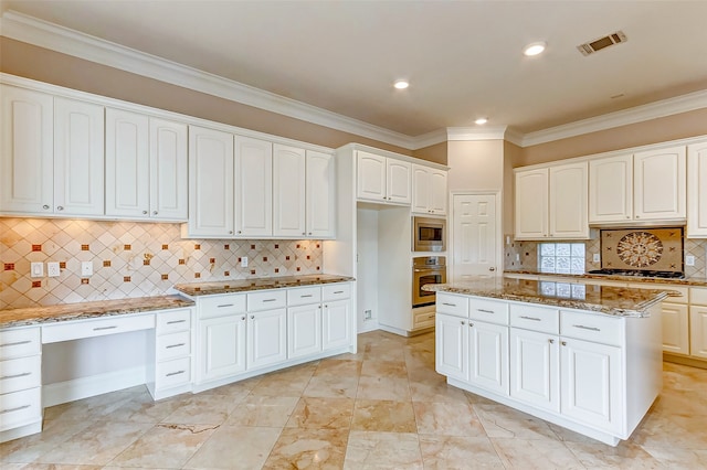 kitchen featuring stone countertops, stainless steel appliances, backsplash, white cabinets, and ornamental molding