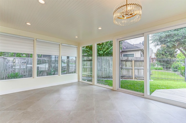 unfurnished sunroom featuring wood ceiling and a notable chandelier