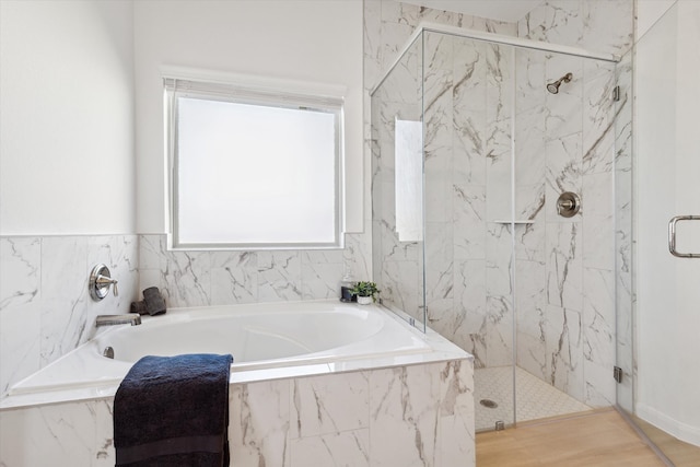 bathroom featuring shower with separate bathtub