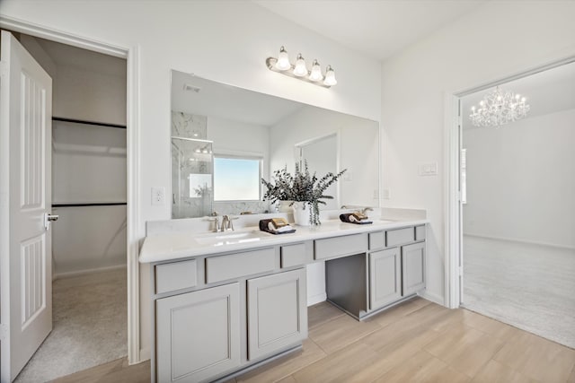 bathroom featuring walk in shower, vanity, and an inviting chandelier